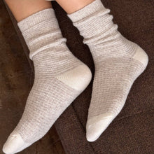 Load image into Gallery viewer, White socks worn on a person&#39;s feet with a brown background
