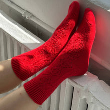 Load image into Gallery viewer, Red socks being worn, with a white radiator in the background

