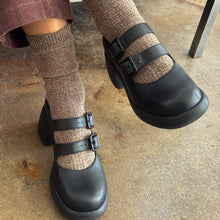Load image into Gallery viewer, Black clogs with brown socks worn on a concrete floor.
