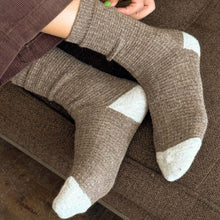 Load image into Gallery viewer, Person wearing brown socks with white toes and heels on a brown couch.
