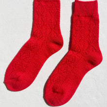 Load image into Gallery viewer, Pair of red socks on a light gray background
